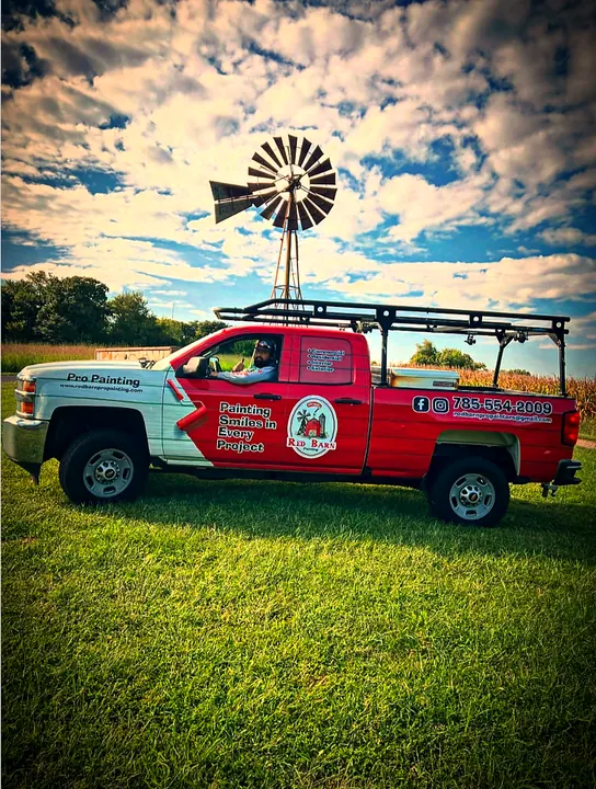 Red Barn Painting work truck under a windmill